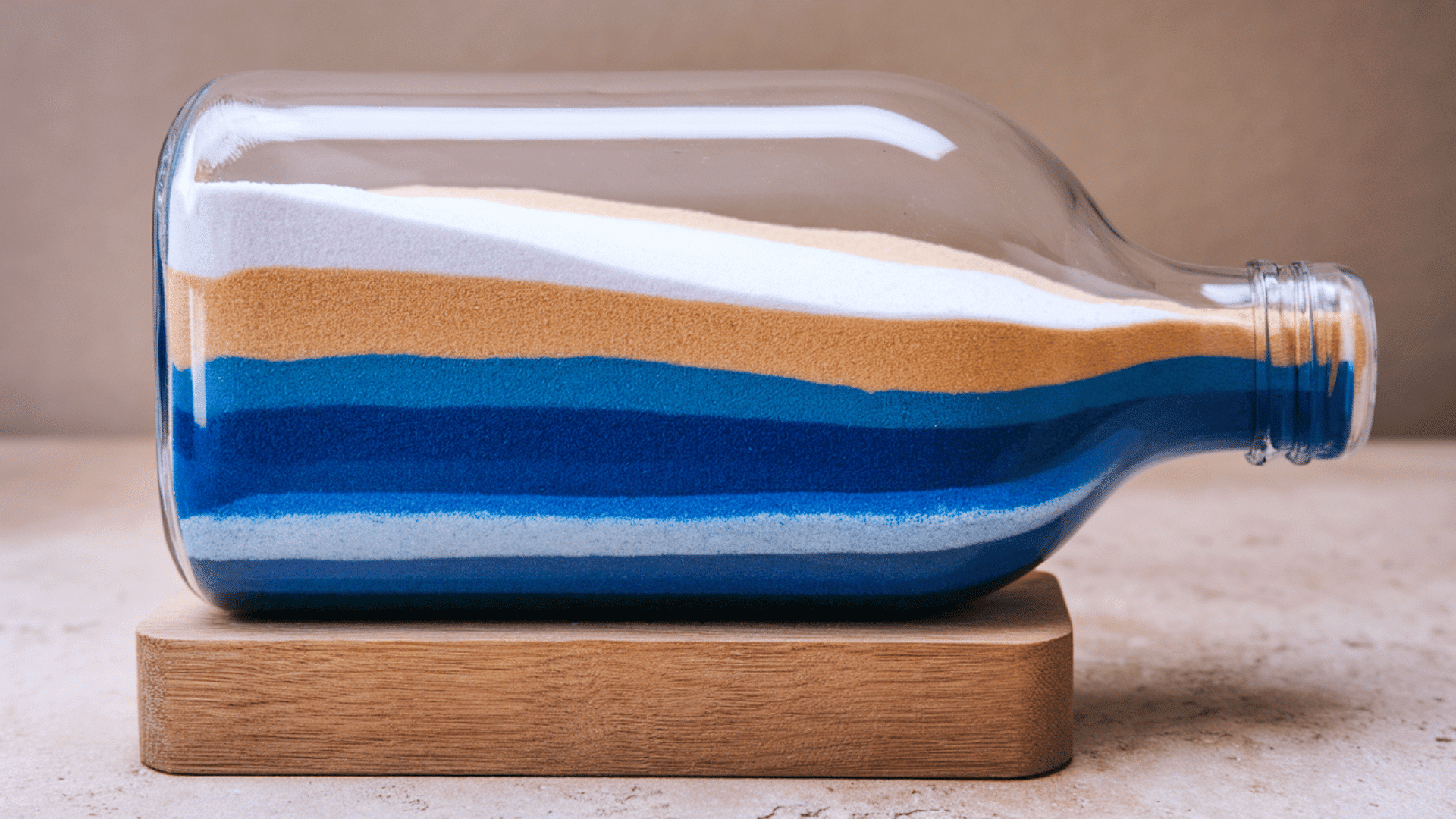 clear bottle filled with layers of colorful sand, beautiful patterns showing