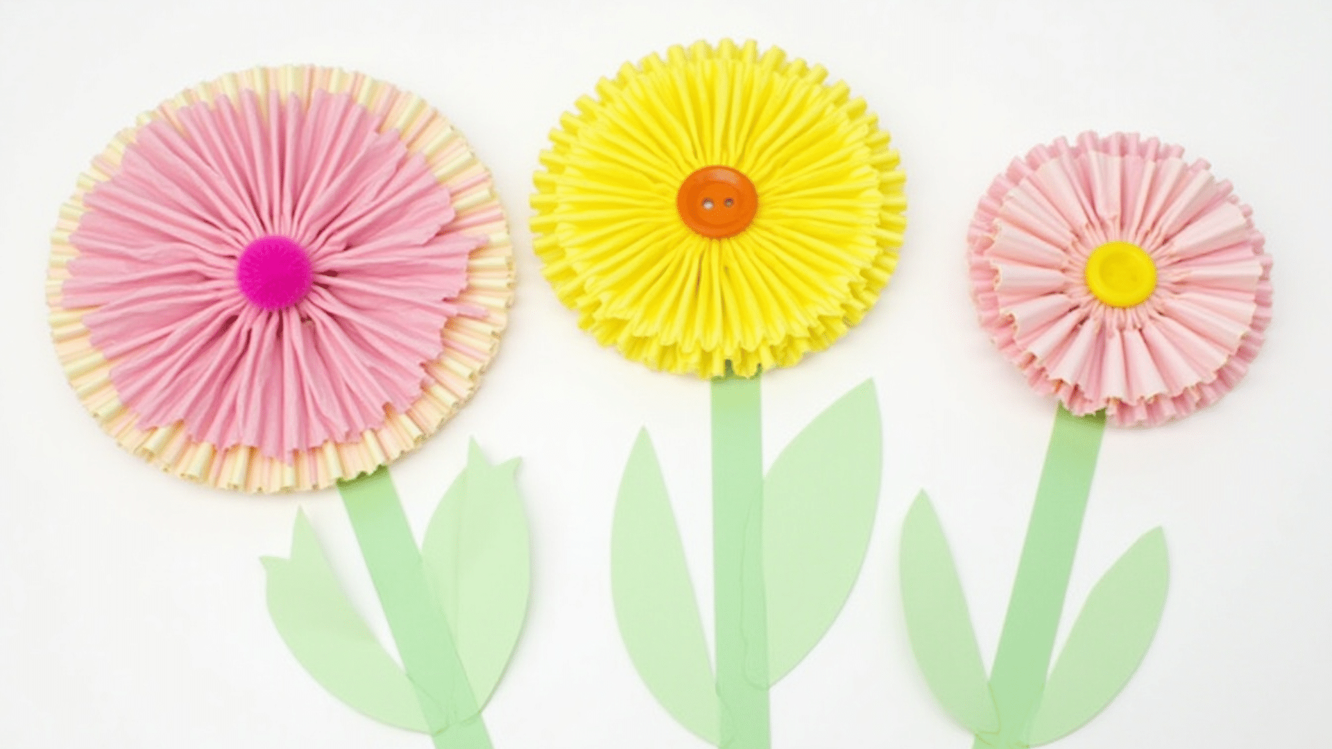 colorful cupcake liners glued onto green paper stems making a simple flower garden scene