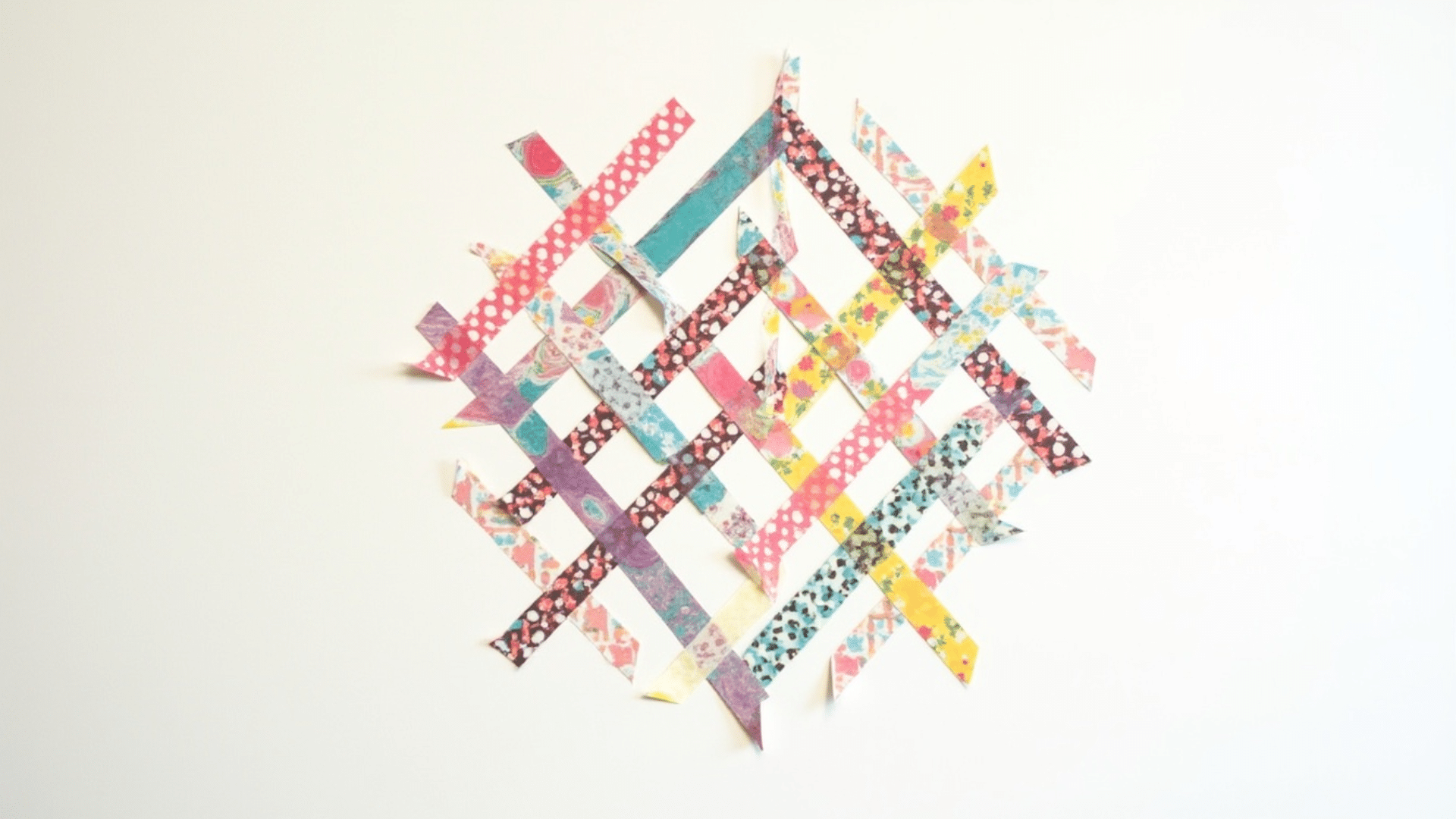 colorful patterned washi tape strips applied to white paper forming a simple geometric design