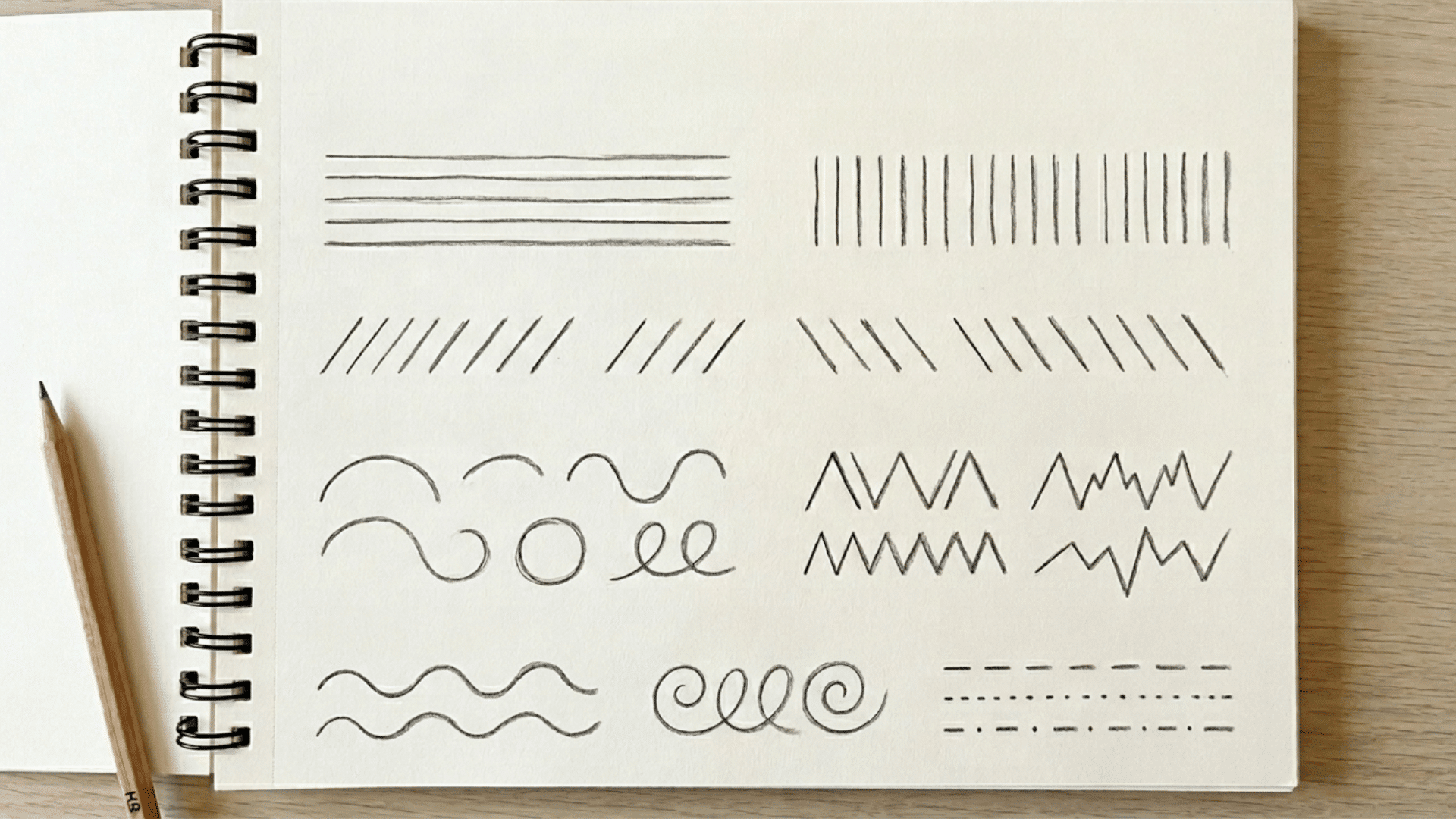pencil sketchbook showing different types of lines including straight curved zigzag and dotted lines