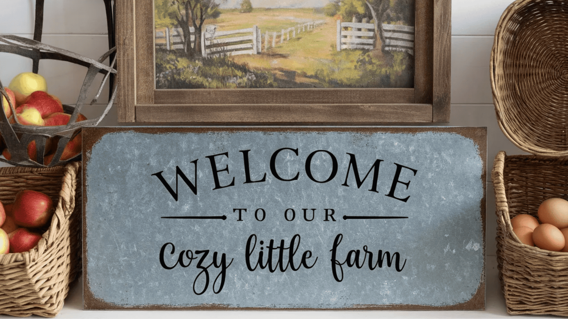welcome to Our Cozy Little Farm_ sign with a vintage design, framed painting, and baskets of apples and eggs