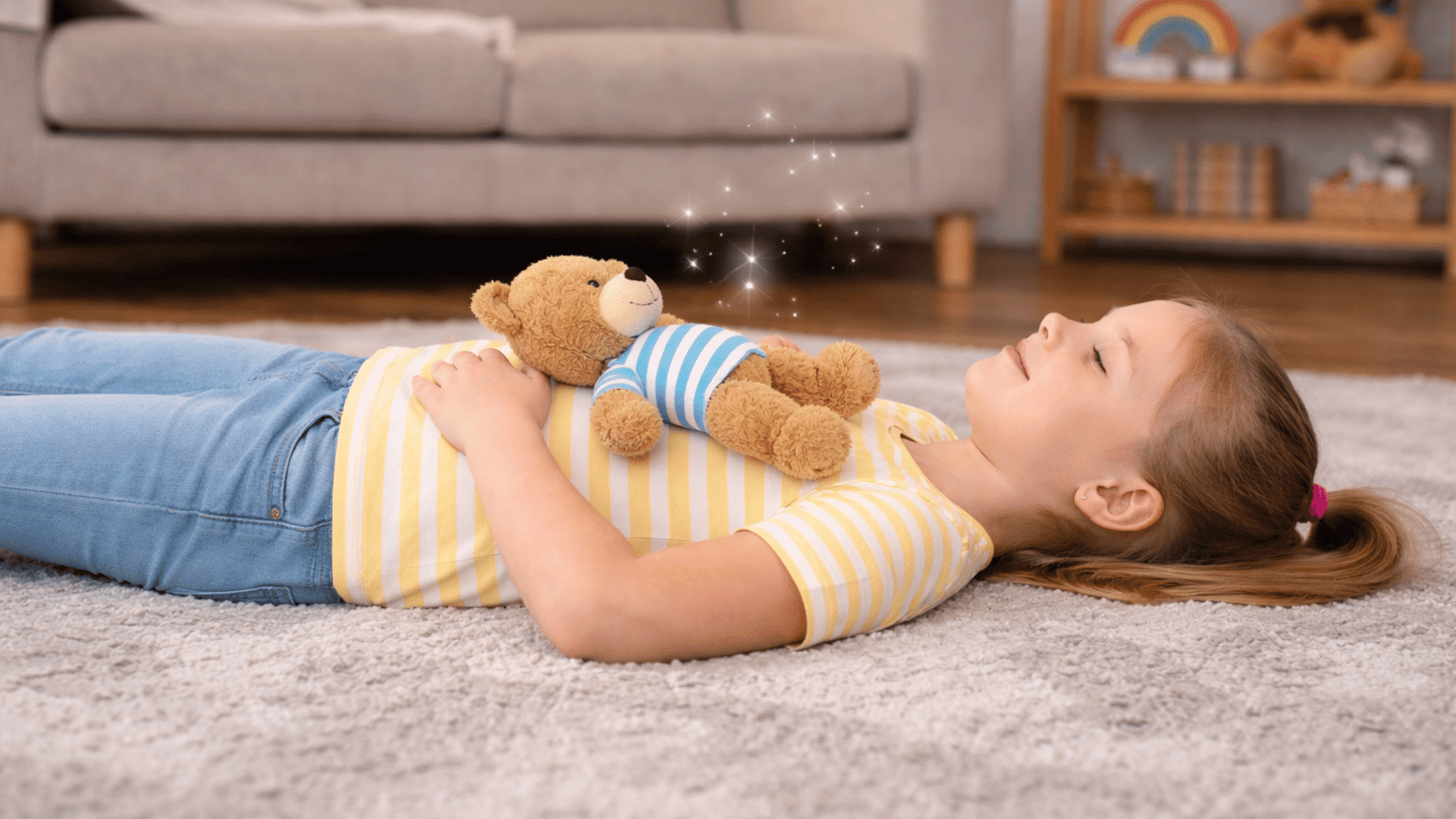a girl lies down with a teddy bear on her belly, practicing breathing with a calm expression.