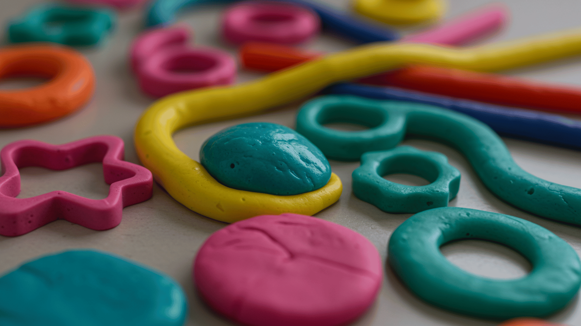 bright slime and play-dough shapes in vivid colors and textures shown in a fun close-up arrangement