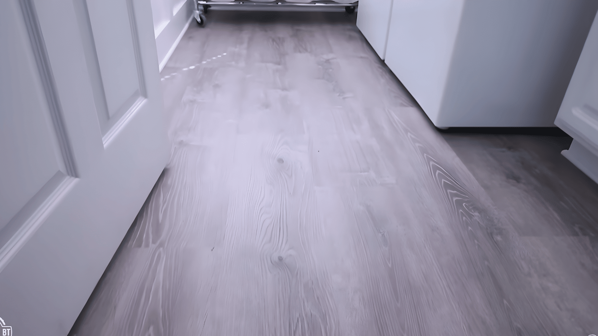 finished vinyl plank flooring installed in a clean, modern laundry room.