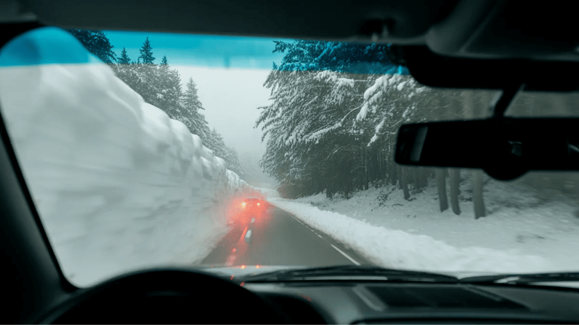 high-contrast photograph taken from the perspective of a driver's dashboard on a Washington highway