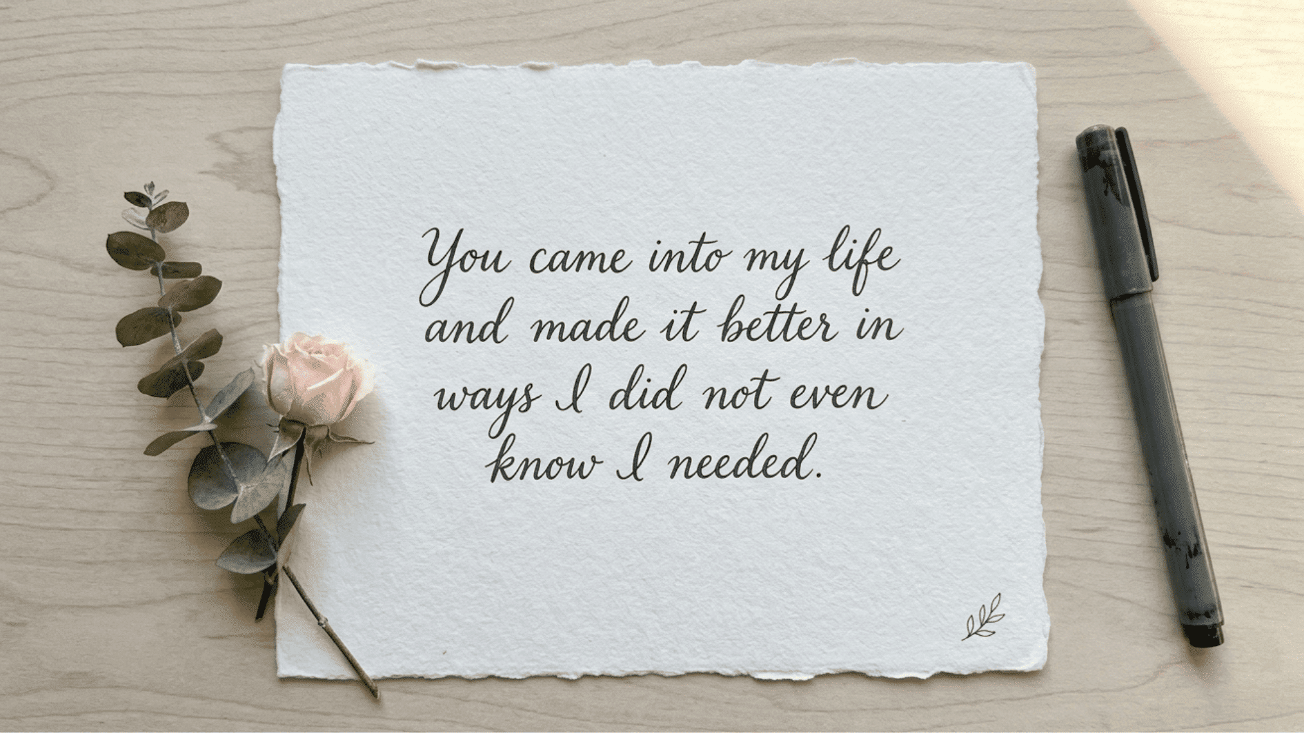 minimal textured card with a heartfelt message about love and life improvement, styled with a rose and pen on a desk