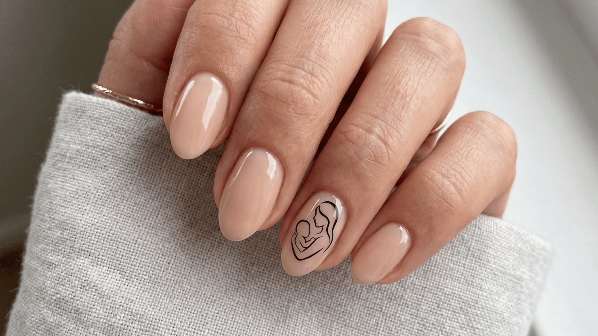 nude nails with black silhouette of mother and baby, minimal style