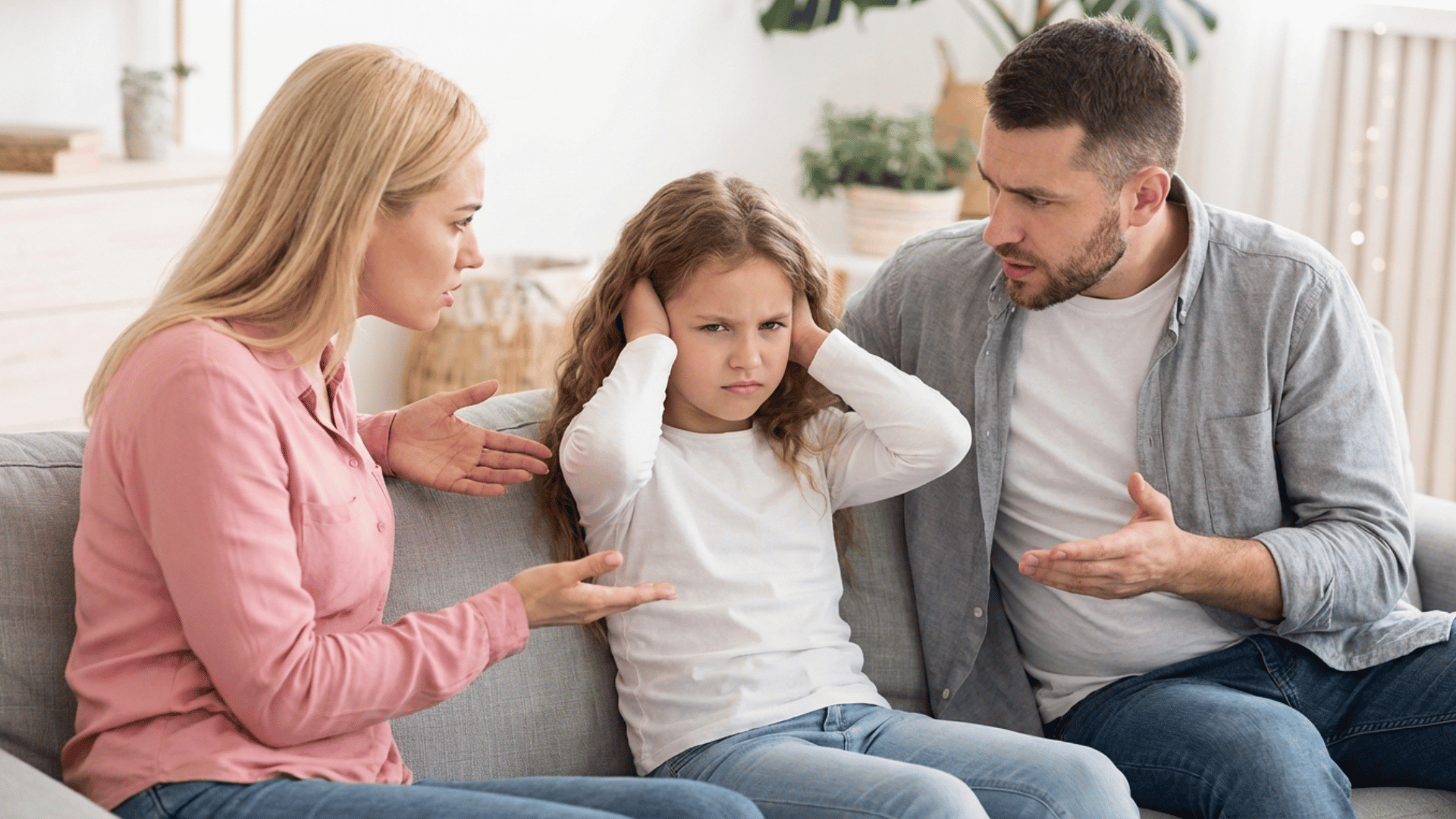 parent and child sitting on a couch using hand gestures to give clear, specific instructions.