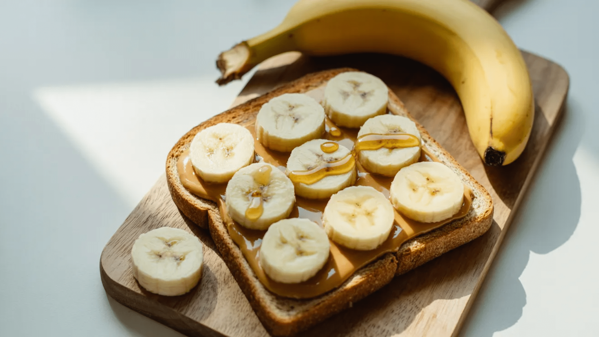 peanut butter toast topped with banana slices and honey