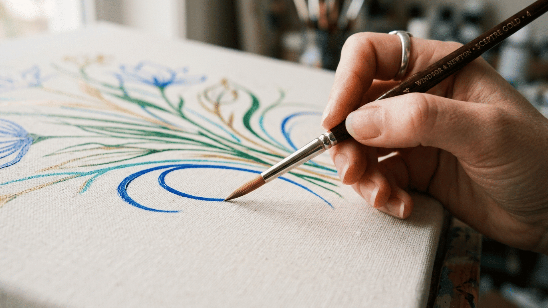 round acrylic paint brush creating fine curved lines on canvas, highlighting detail work with controlled acrylic paint brushe