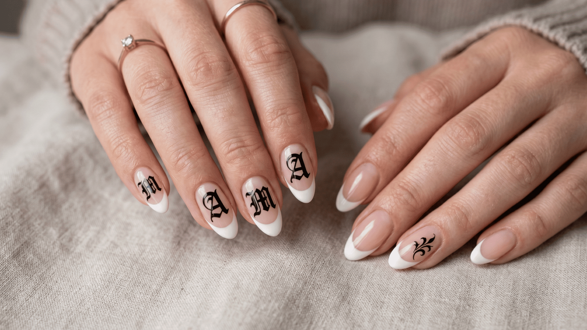 soft french tip with the bold Gothic “mama” lettering scattered across each nail is such a statement look