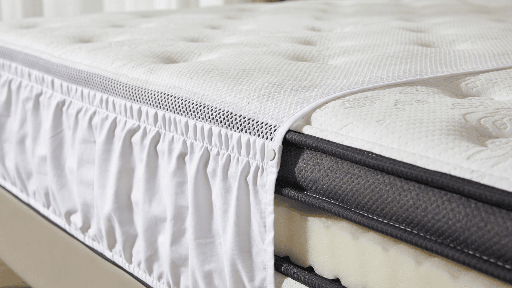 a plush guest bedroom mattress with a memory foam topper, mattress protector, and crisp white sheets
