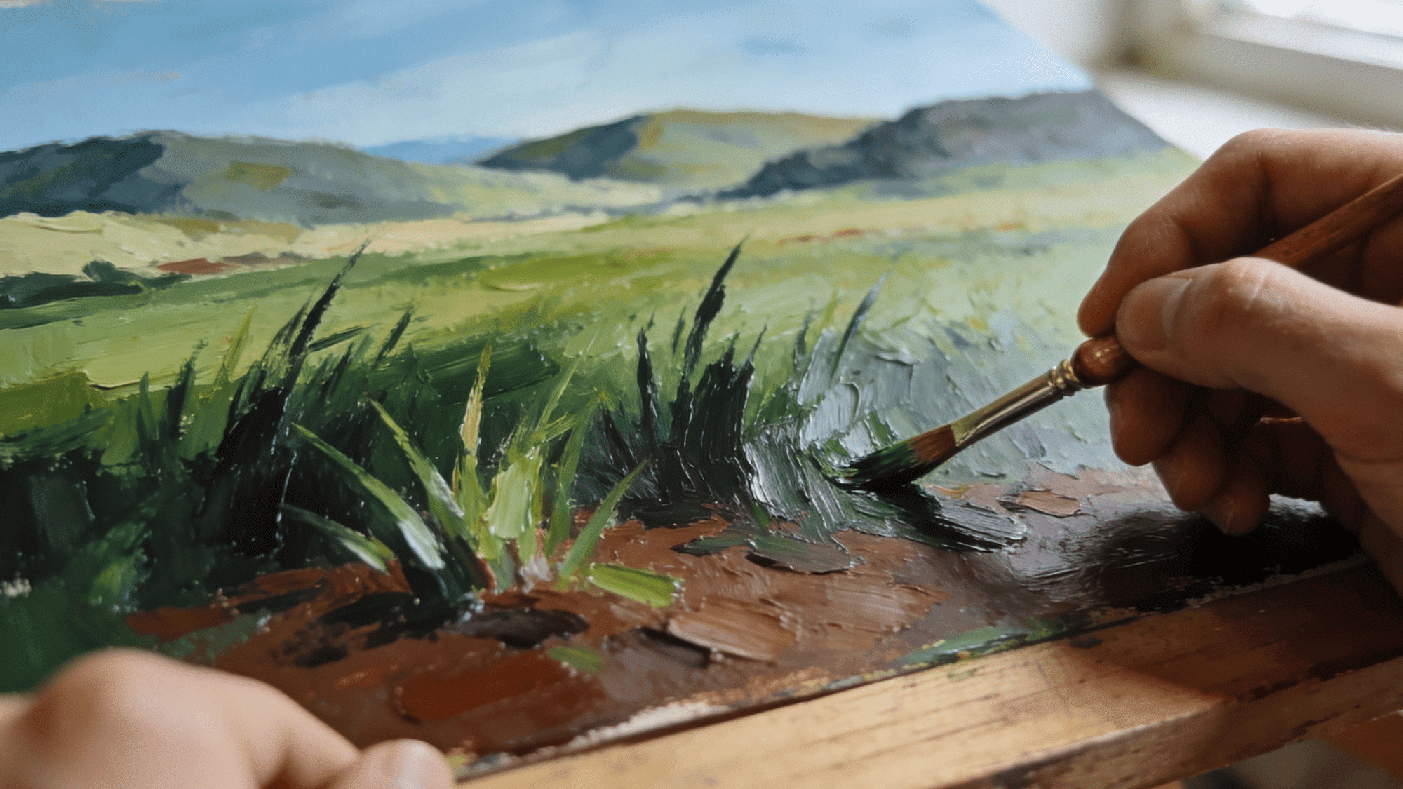 closeup artist painting grassy landscape with oil paints and detailed brush technique (1)