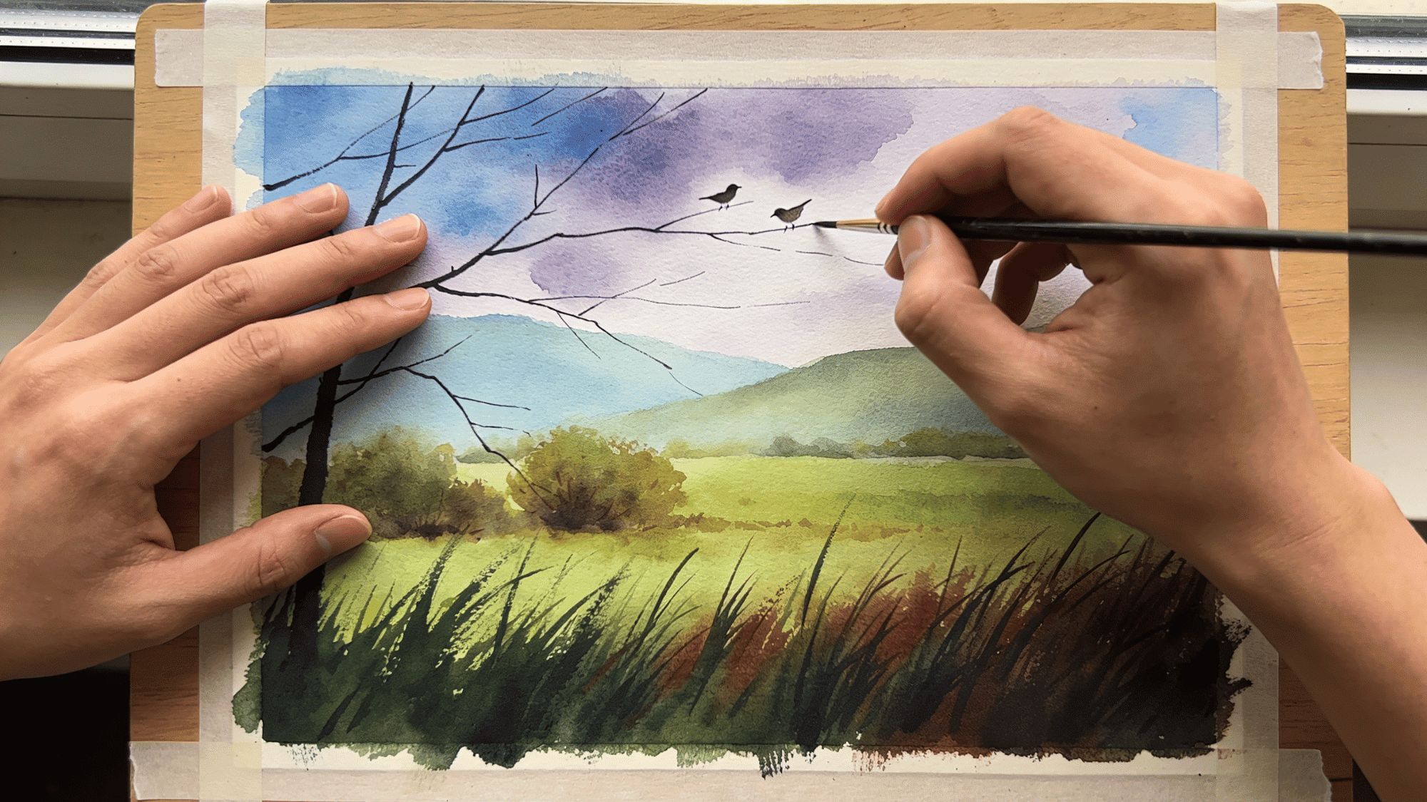 finished watercolor landscape artwork with birds trees hills and dramatic colorful sky