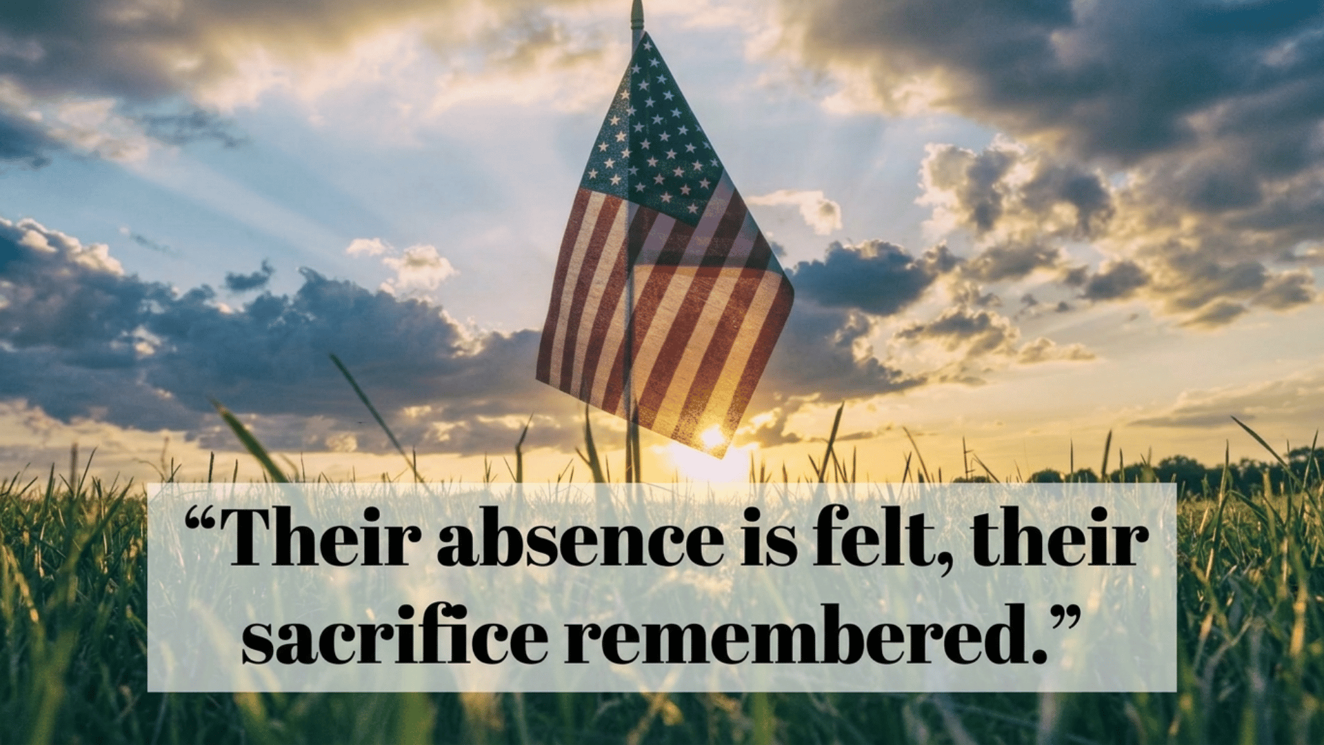 memorial Day remembrance quote displayed over an American flag at sunset in a peaceful grassy field scene.