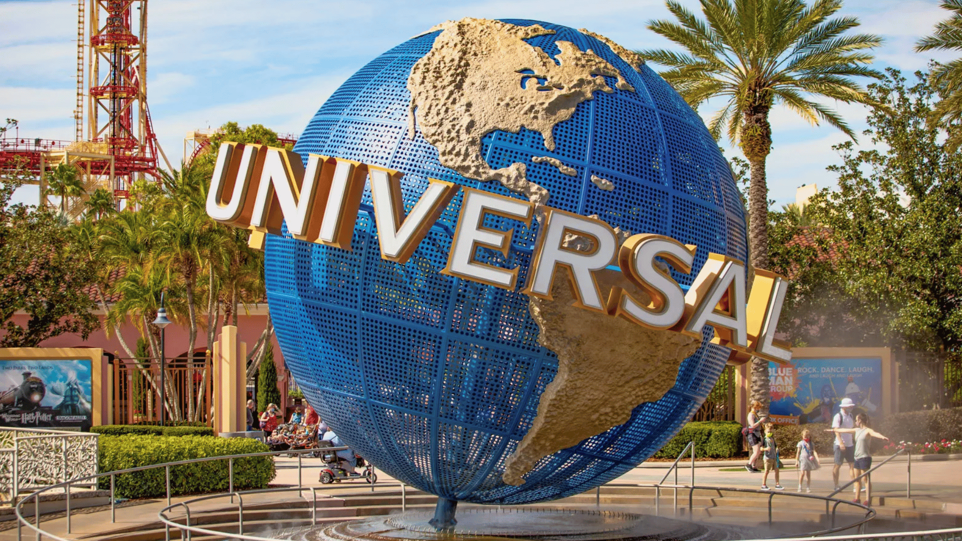 visitors walking near the universal studios globe during a sunny memorial day weekend afternoon