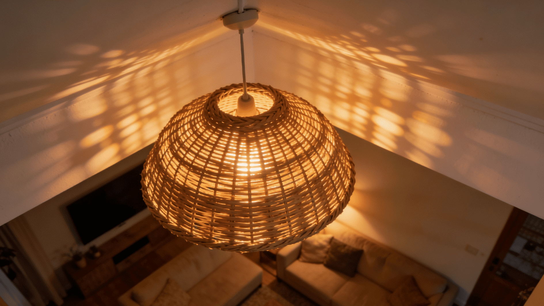 woven pendant light casting warm patterned shadows over cozy modern living room interior