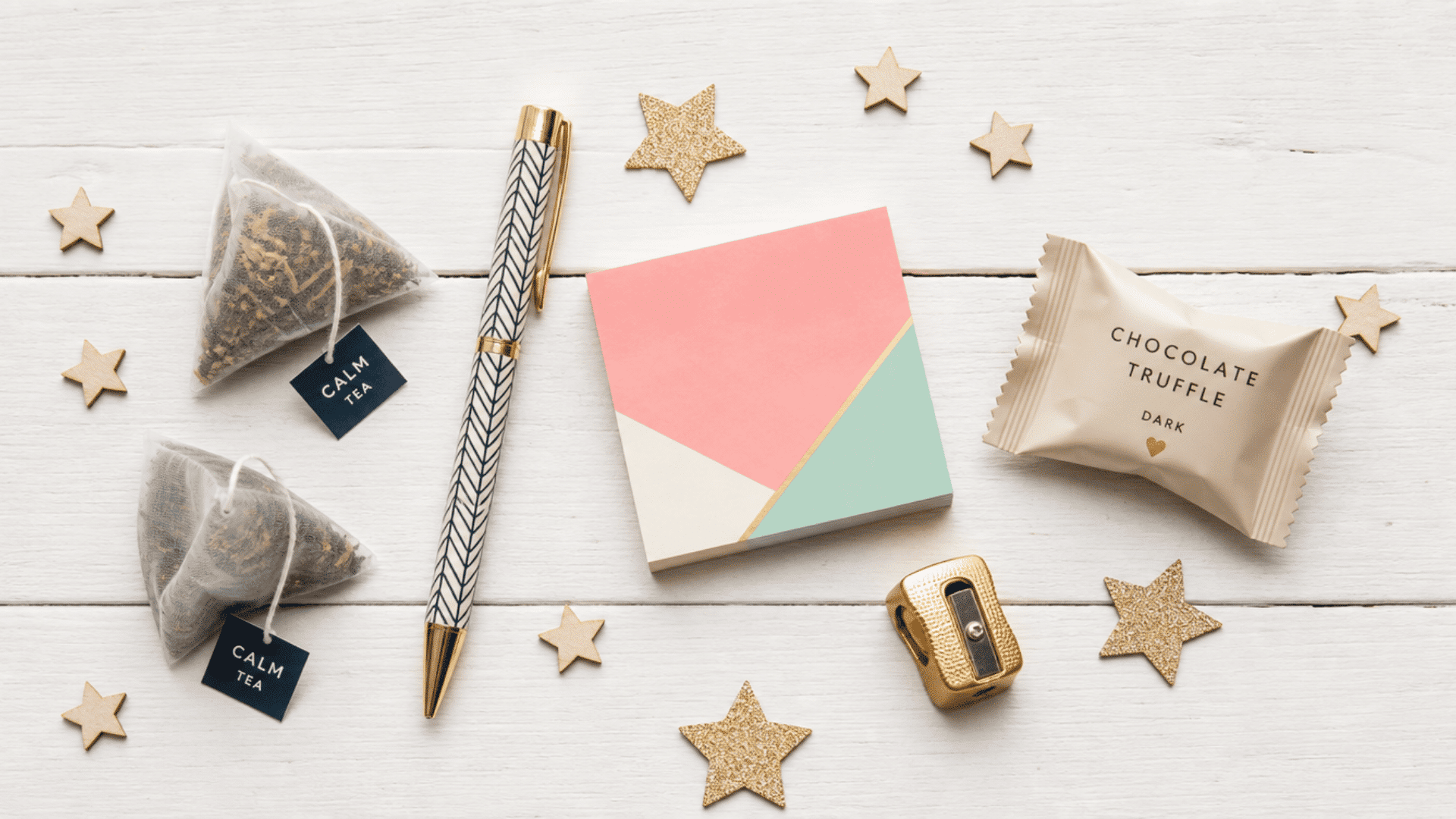 coworker advent calendar with tea bags, pen, sticky notes, gold sharpener, and chocolate truffle