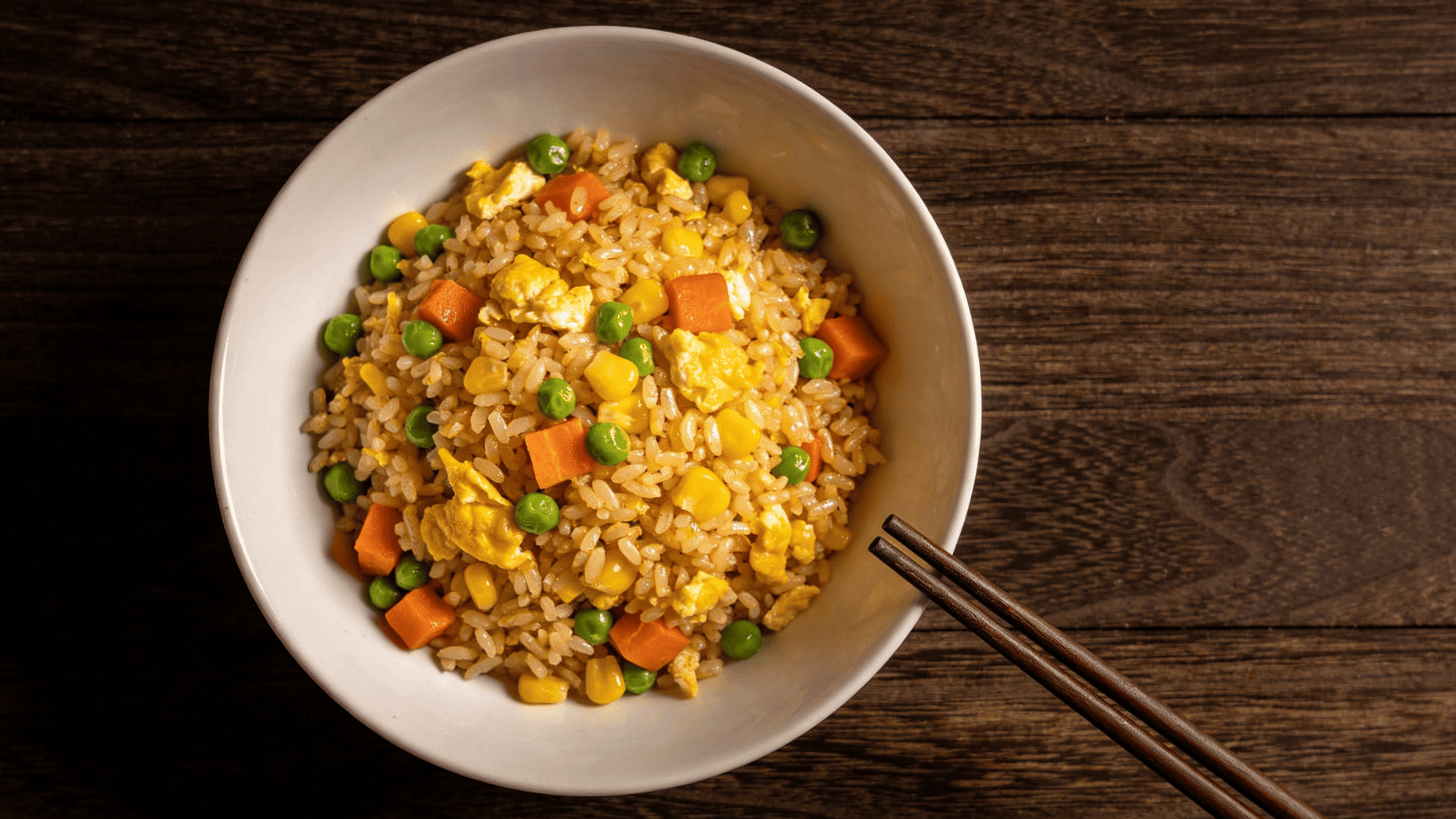 egg fried rice with peas carrots and corn in white bowl, quick healthy meal ideas for kids
