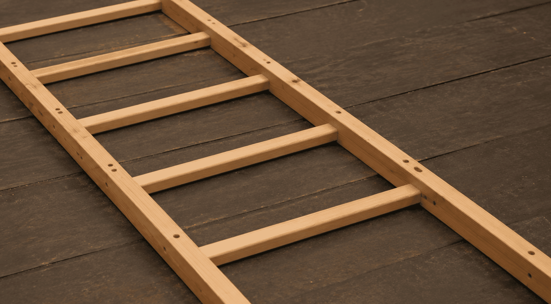 cut and test-fit wooden dowel rungs into drilled side rails during blanket ladder assembly process