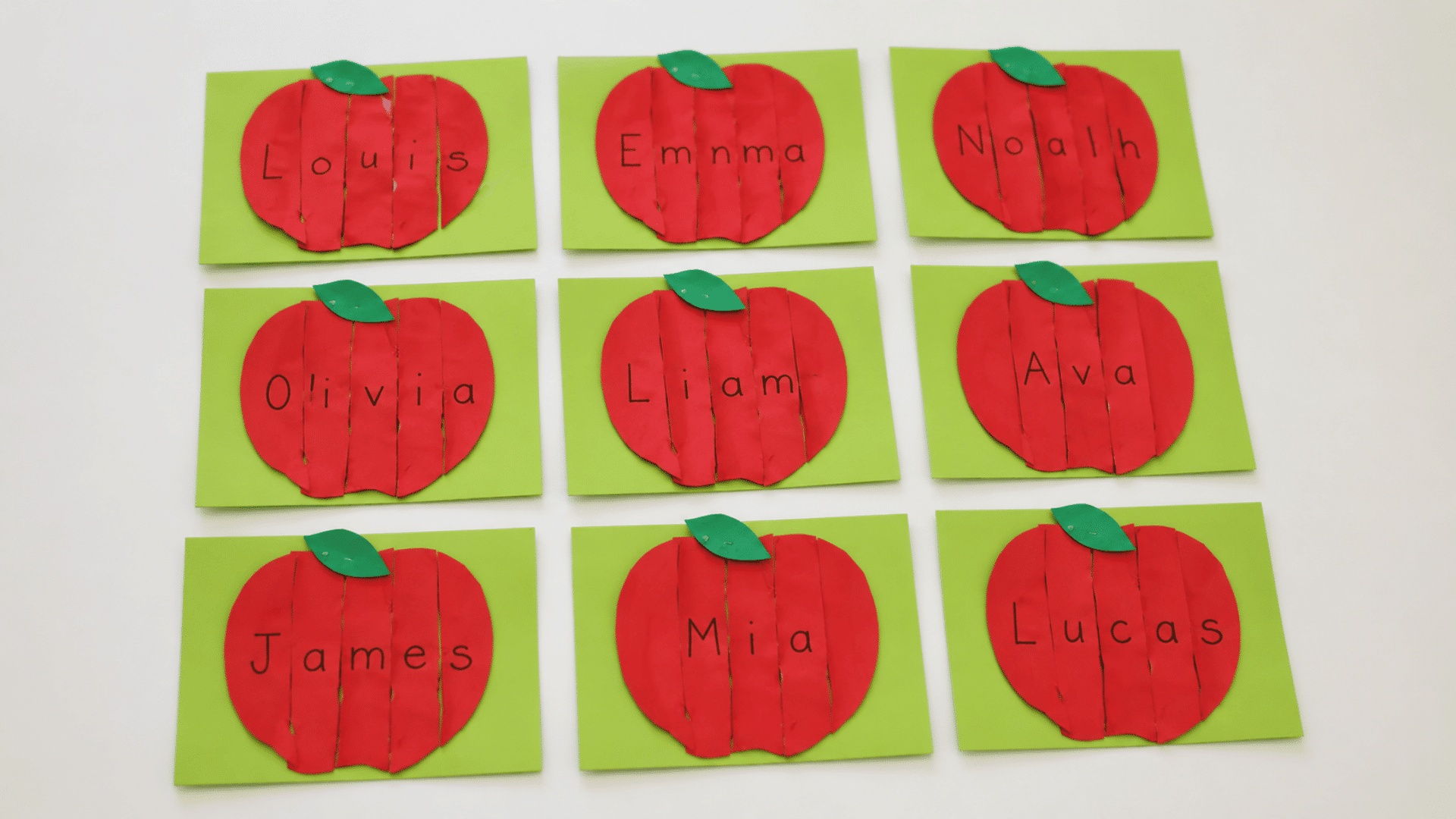 image of a tabletops with apple name cards craft in column margin cuts and pasted pieces toddler apple craft ideas