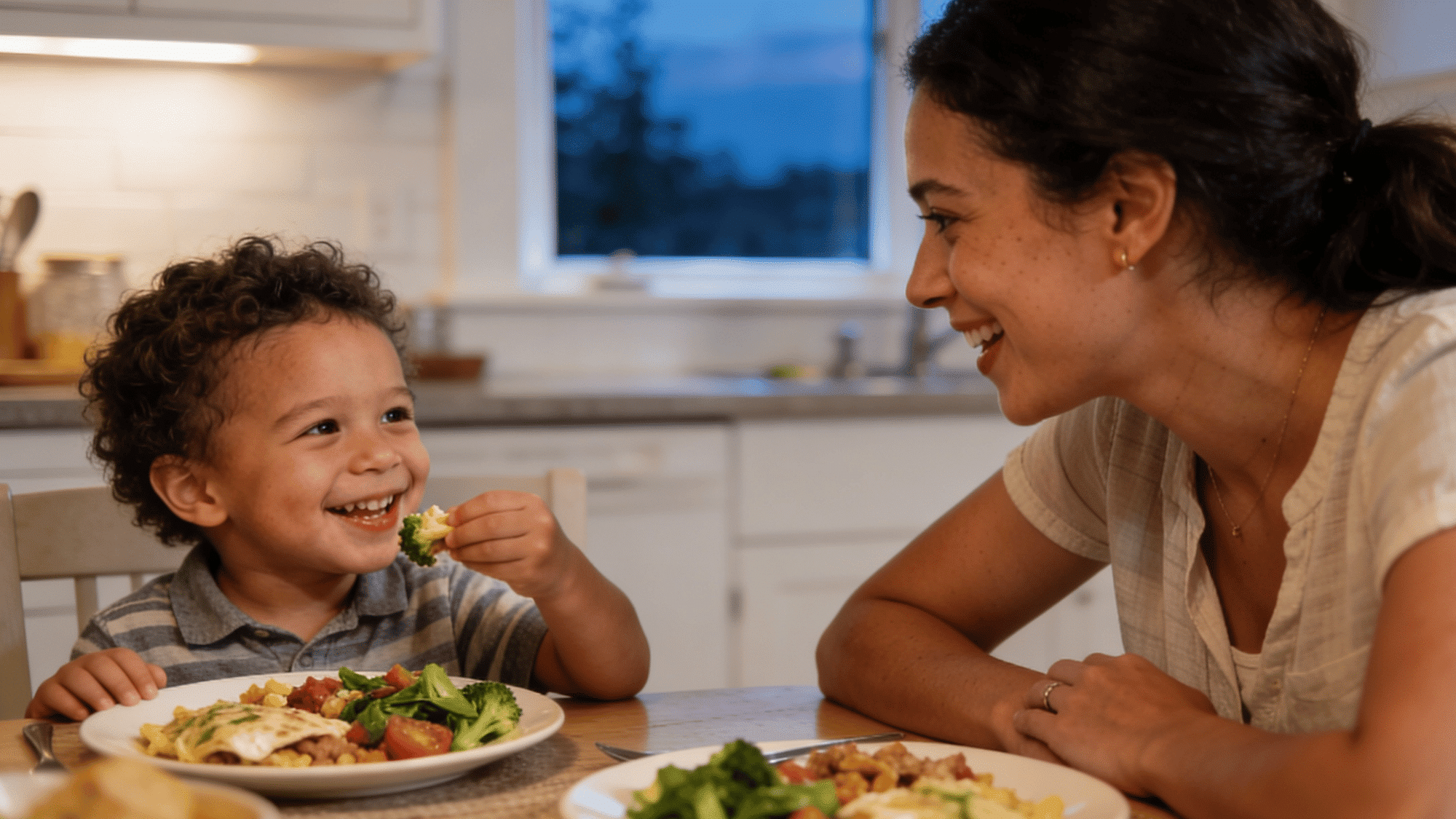 mom and young child eating dinner together at kitchen table, warm candid family mealtime photo