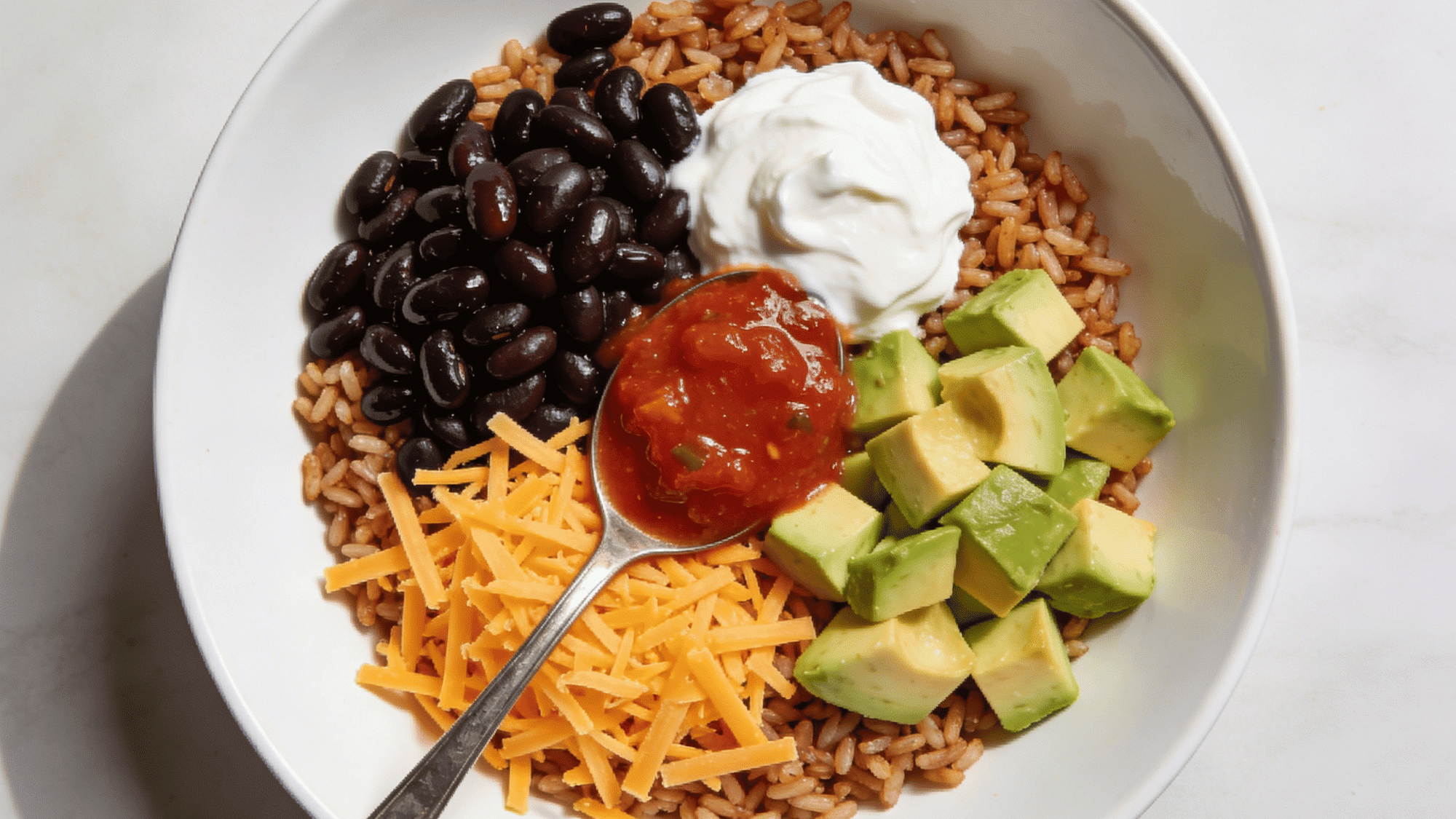 rice and bean burrito bowl with black beans cheese salsa and avocado, healthy quick meal ideas for kids