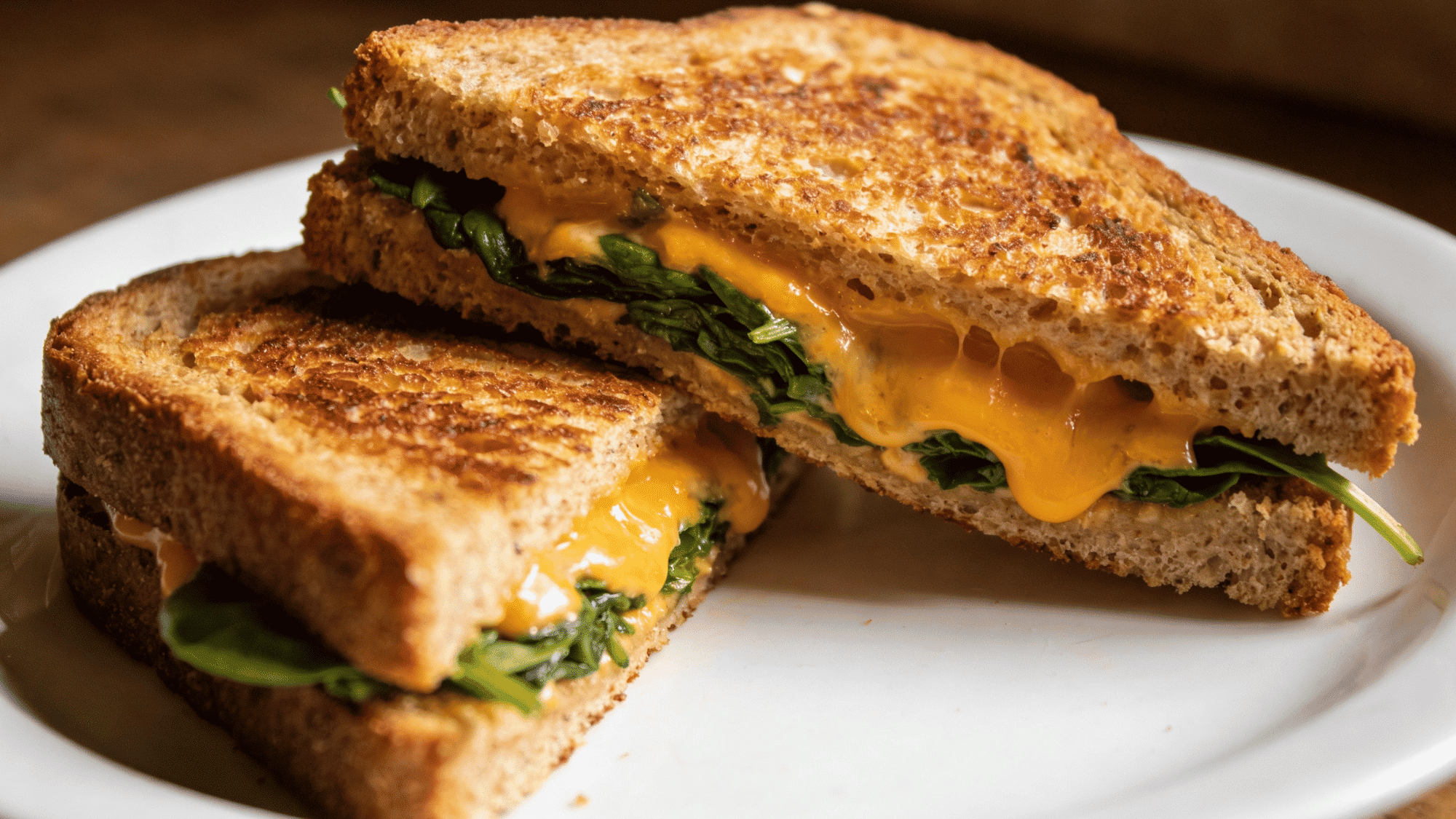 veggie grilled cheese cut in half showing melted cheddar and spinach inside, healthy meal ideas for kids