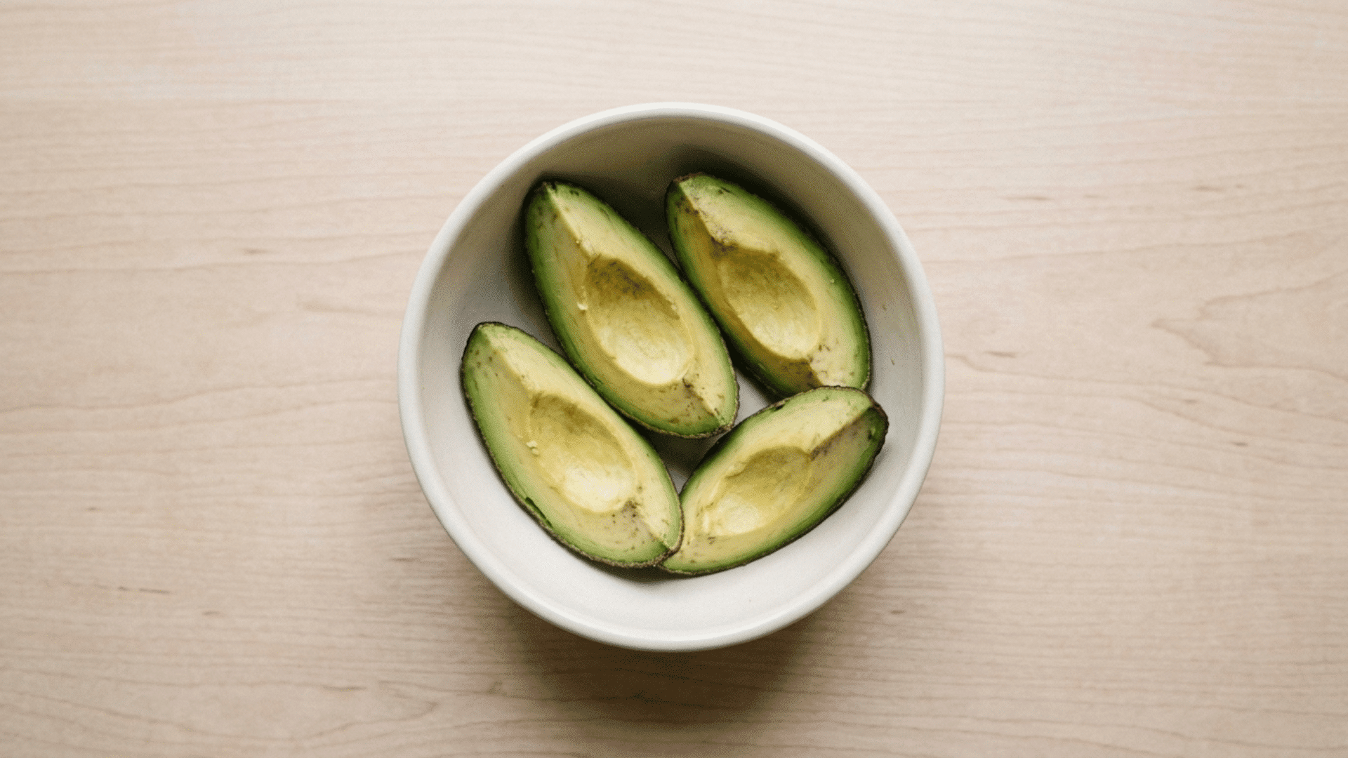 avocado wedges with skin on served in a divided toddler tray for baby led weaning recipes