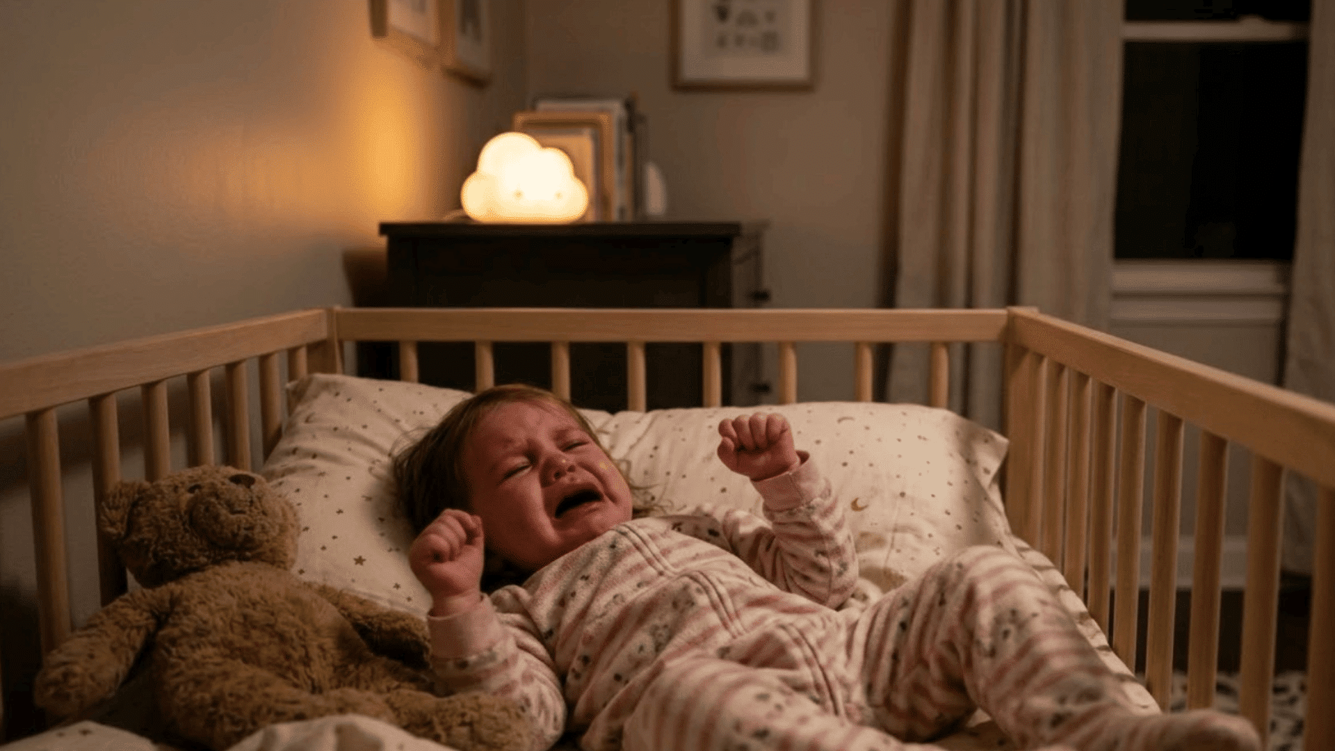 baby crying in a crib at night with a teddy bear and dim bedroom lighting during sleep disruption