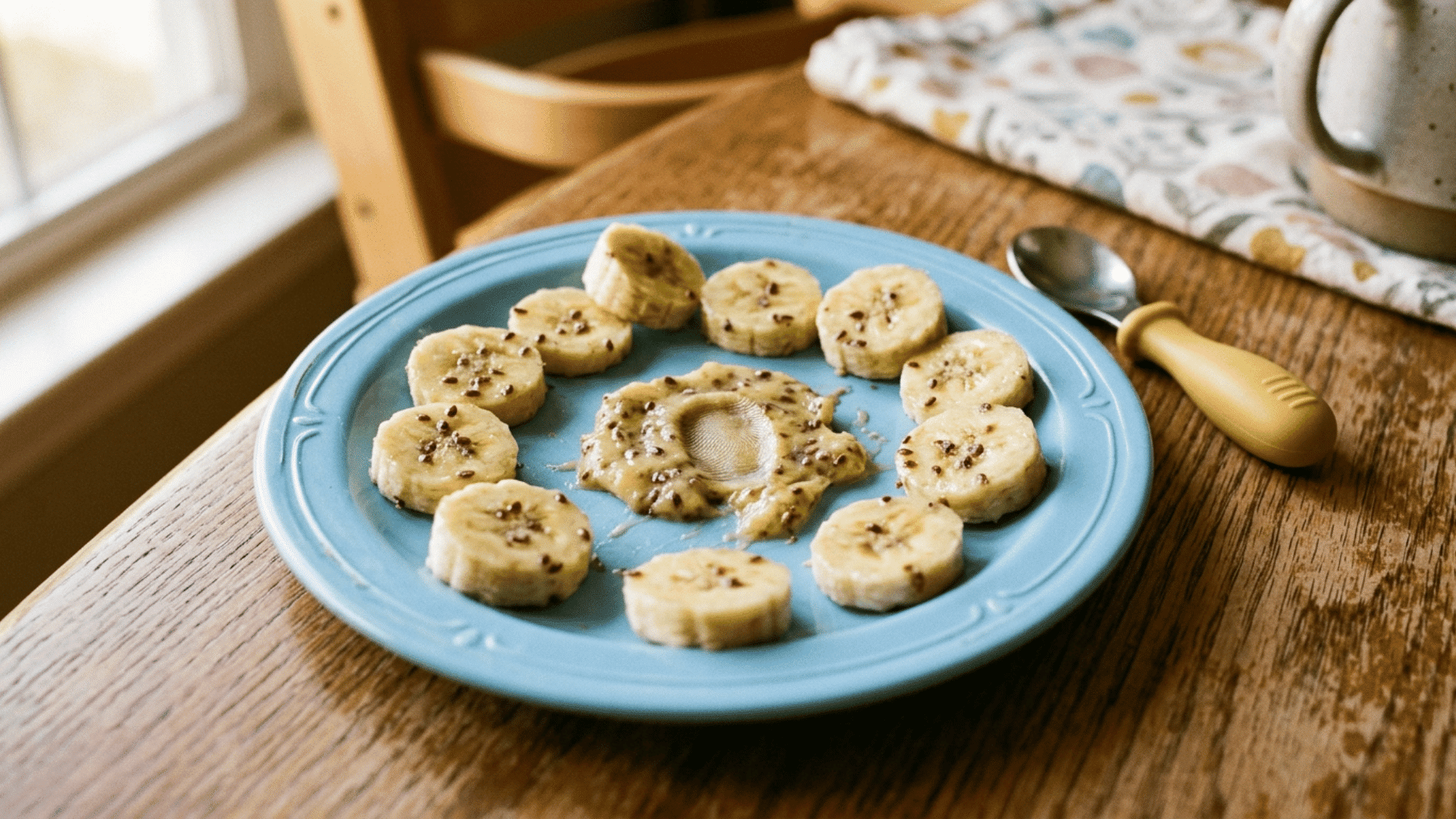 banana coins dusted with ground flaxseed on a round toddler plate for easy baby dinner