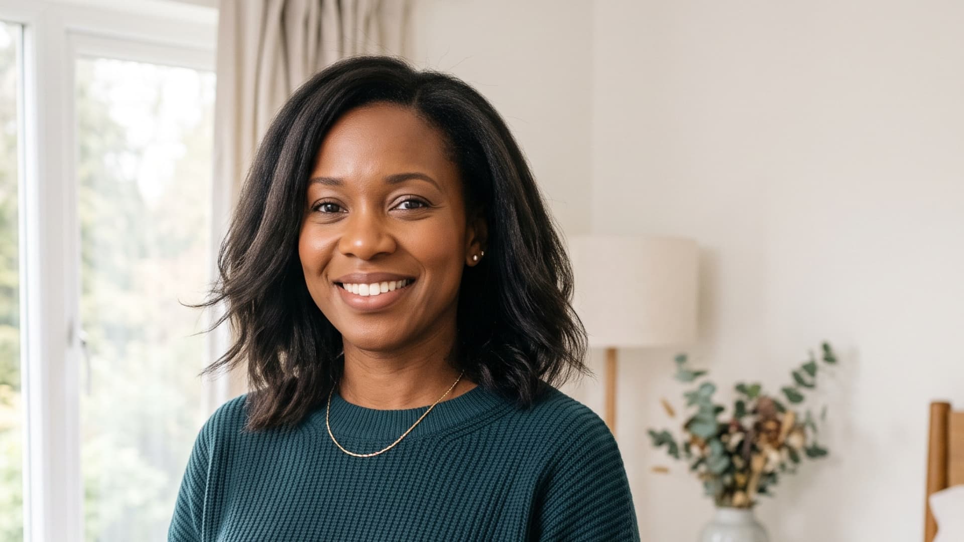 black woman with a collarbone lob featuring softly straightened hair and gentle movement at the ends