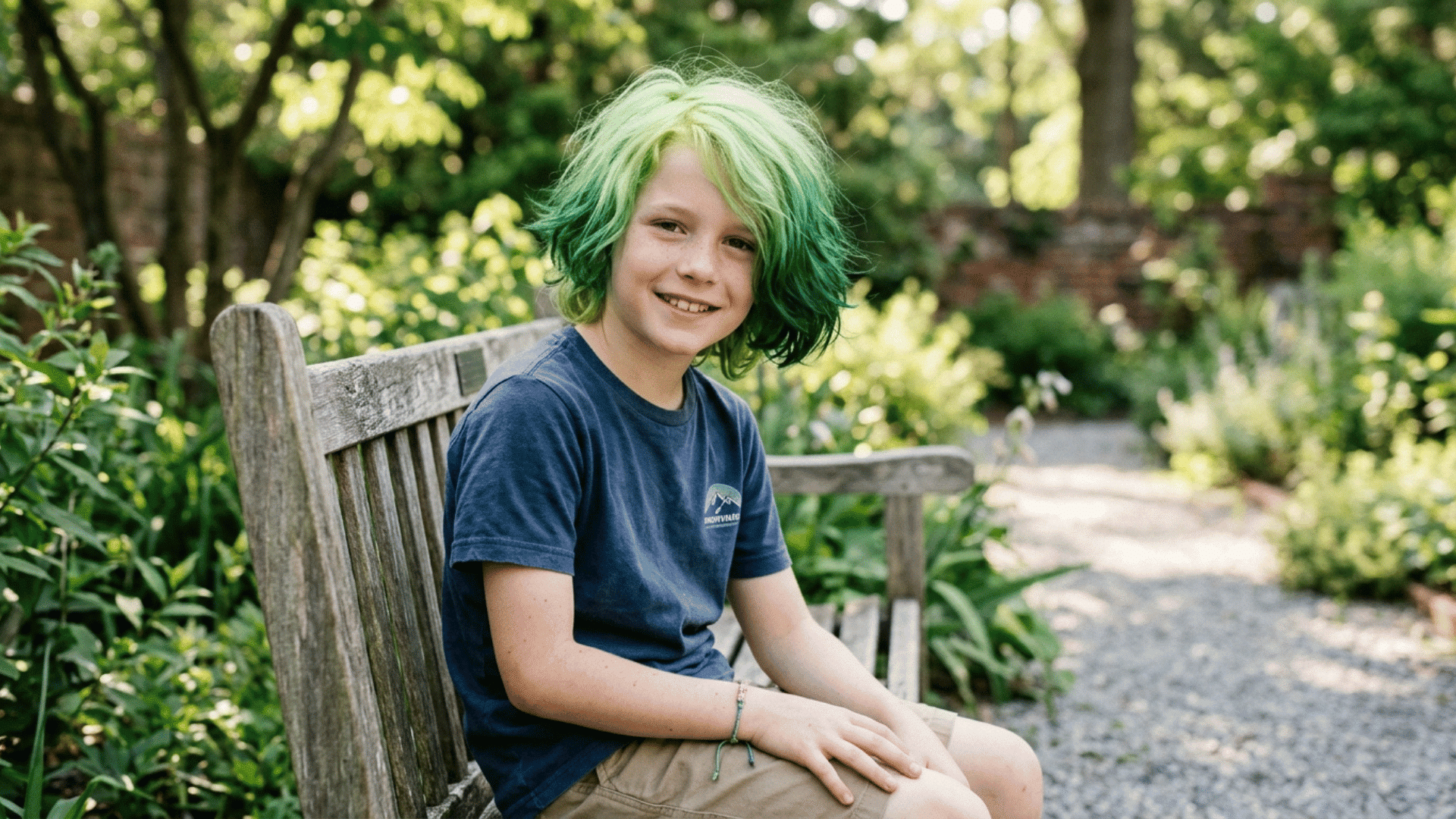 light green roots fading to deep green tips on a boy's hair