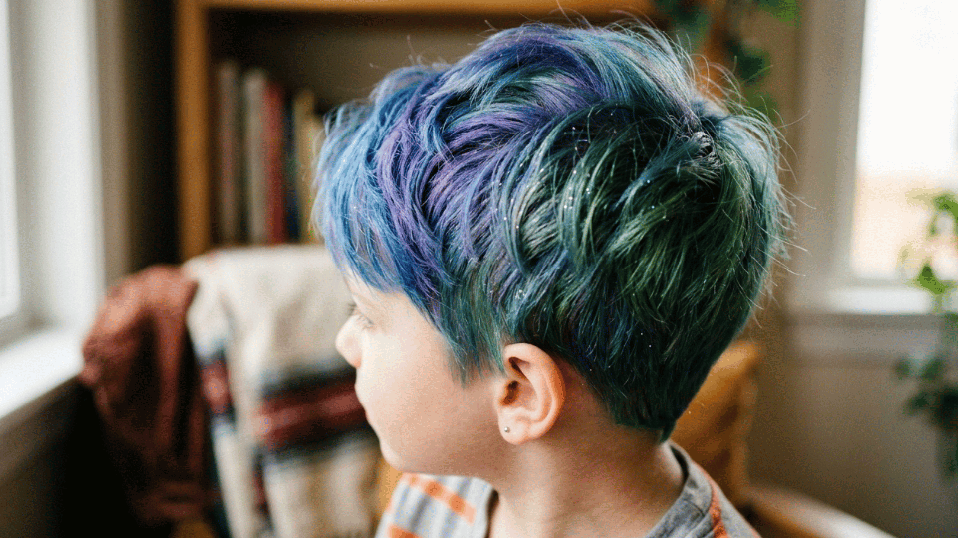 light glitter spray shining on a boy's colored short hair