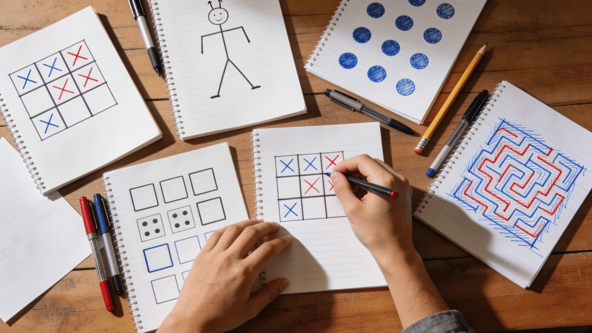 collage of pen and paper games on notebooks including tic tac toe hangman maze sudoku word chain grid puzzles