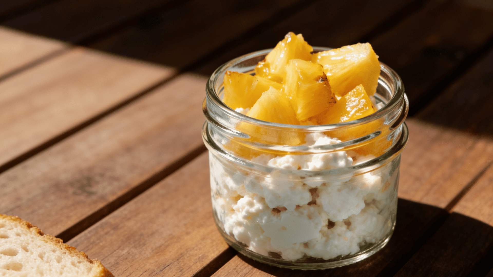 cottage cheese topped with pineapple in a transparent glass container