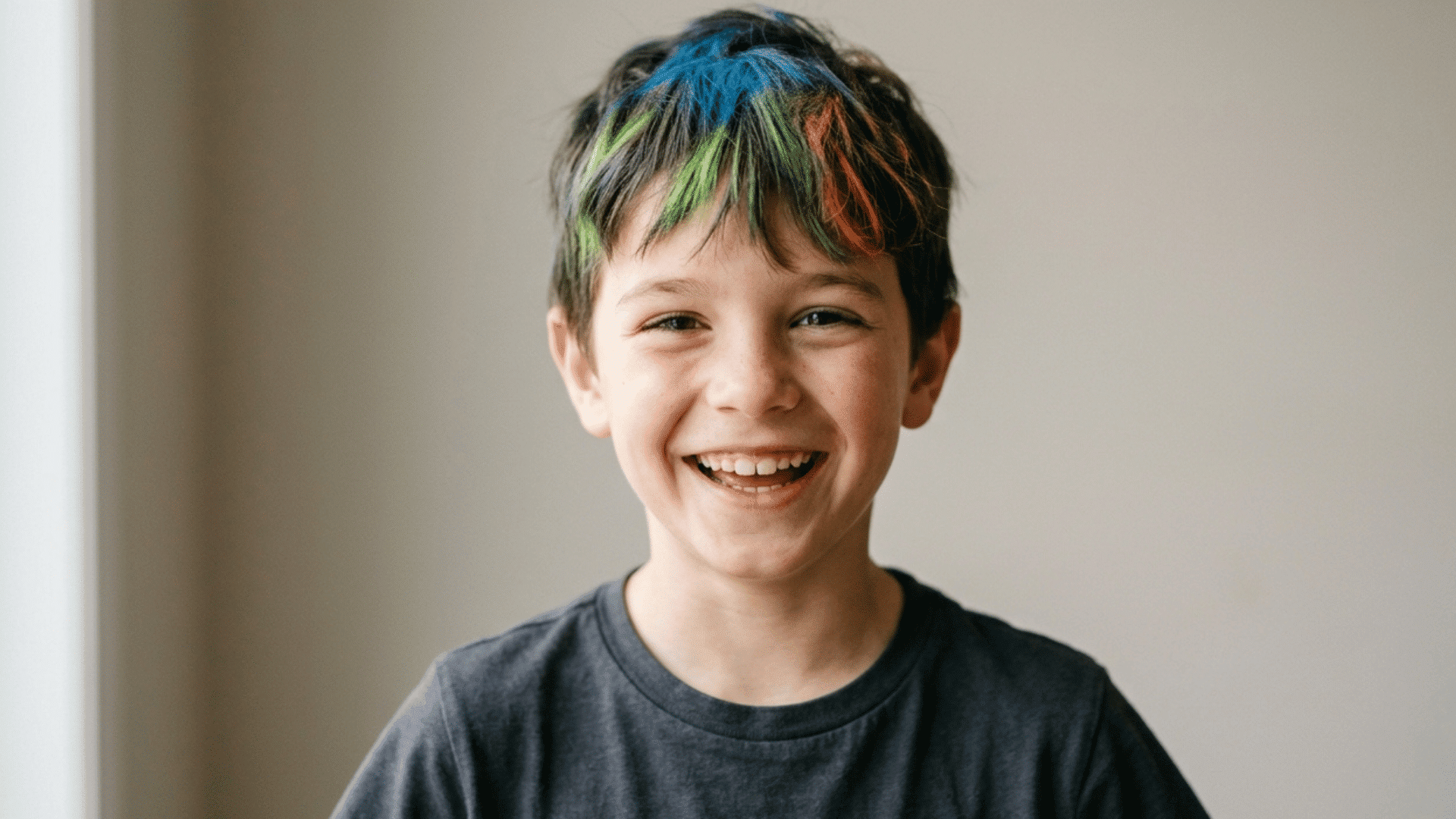 boy smiling with simple bright colored crazy hair day style