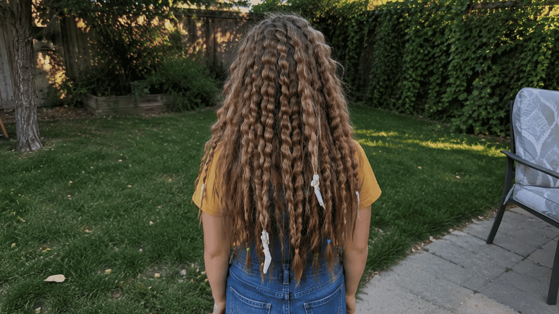 crimped zigzag curls with paper strip ties still in ends in backyard