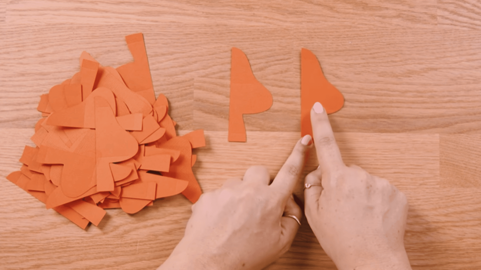 cut mushroom shapes from cardstock and sorting pieces into two piles based on score line positions