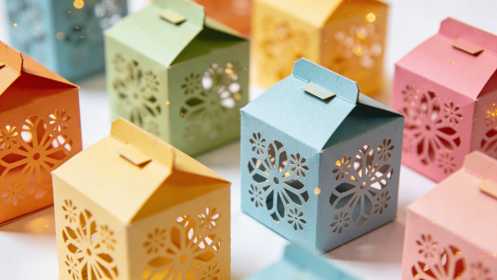 decorative gift boxes made from simple paper with decorative cutout shapes on the sides for elegant detail.
