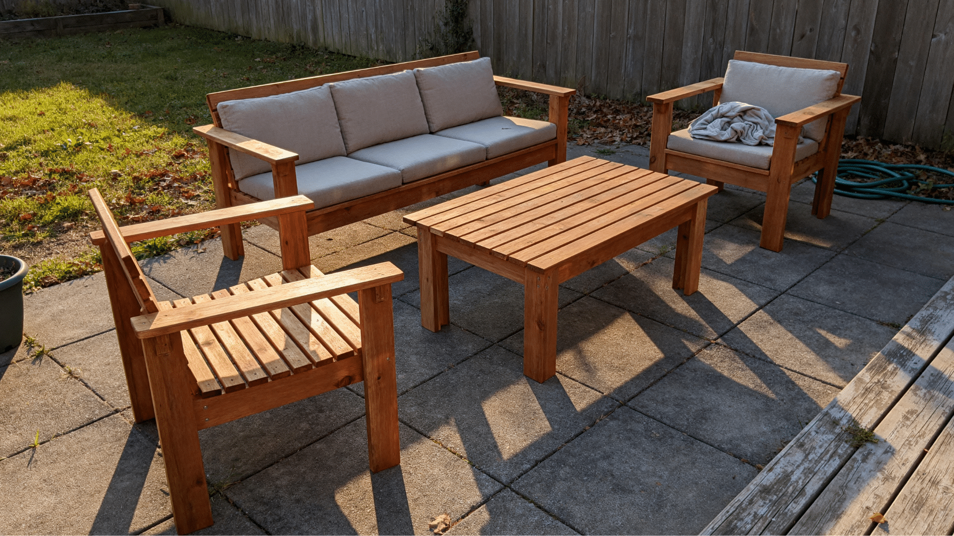 Handmade wooden DIY outdoor patio chair on a sunlit patio