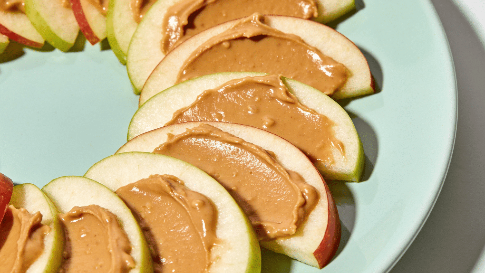 fresh apple slices spread with a light layer of nut butter