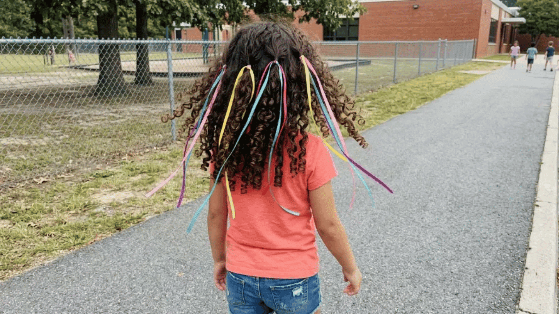 girl with rainbow spiral pipe cleaners twisted into pigtails, outdoor deck, candid crazy hair day photo (1)