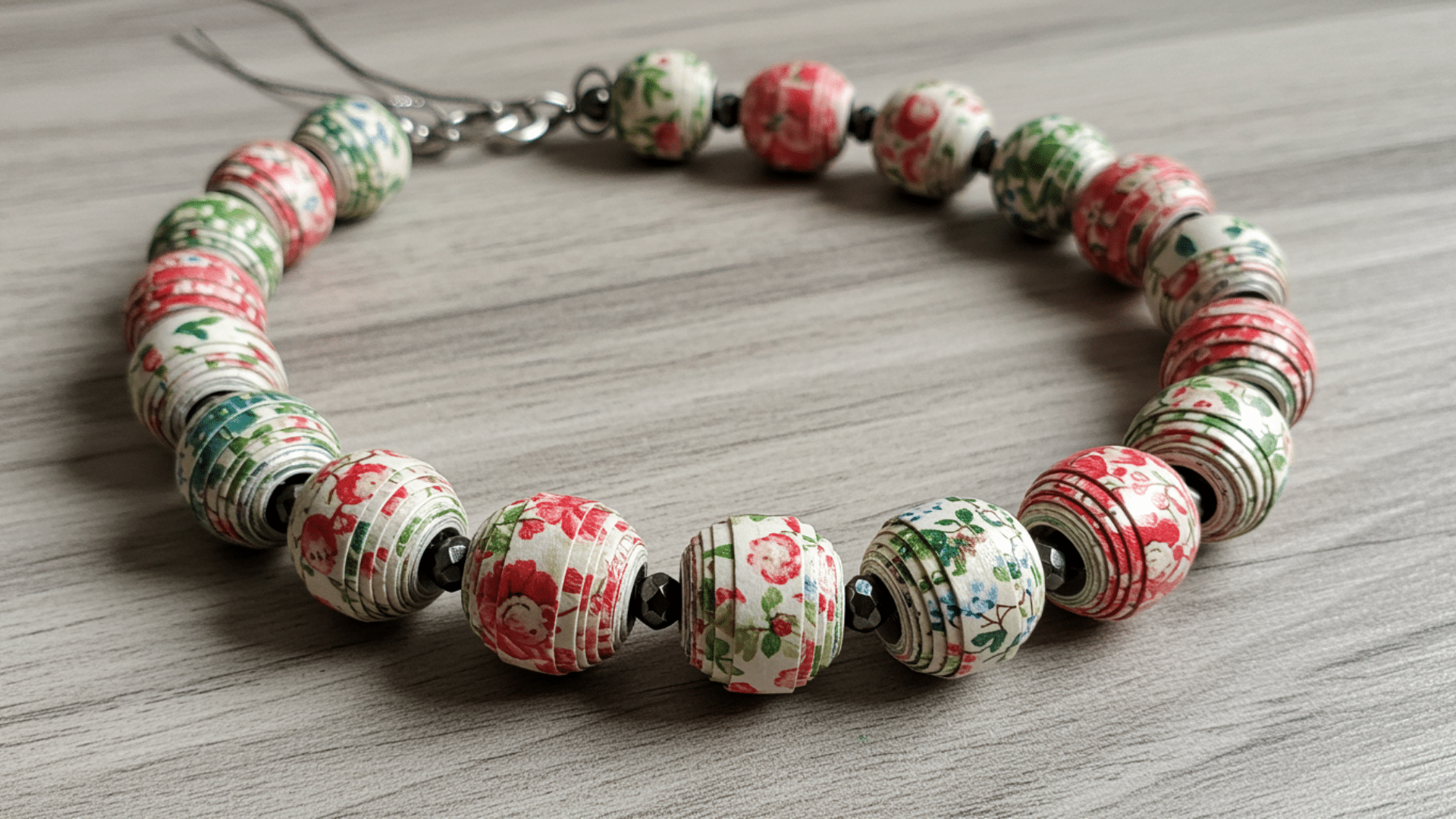 handmade bracelet made from rolled paper beads in assorted colors and patterns
