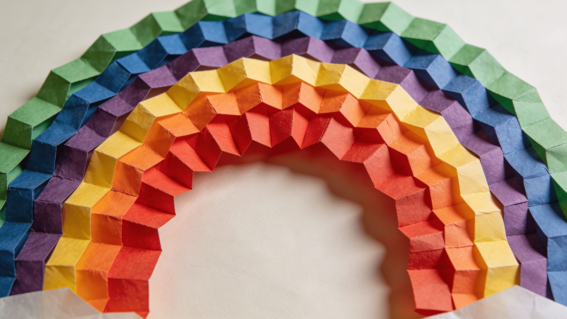 layered rainbow made from curved strips of colored paper strips