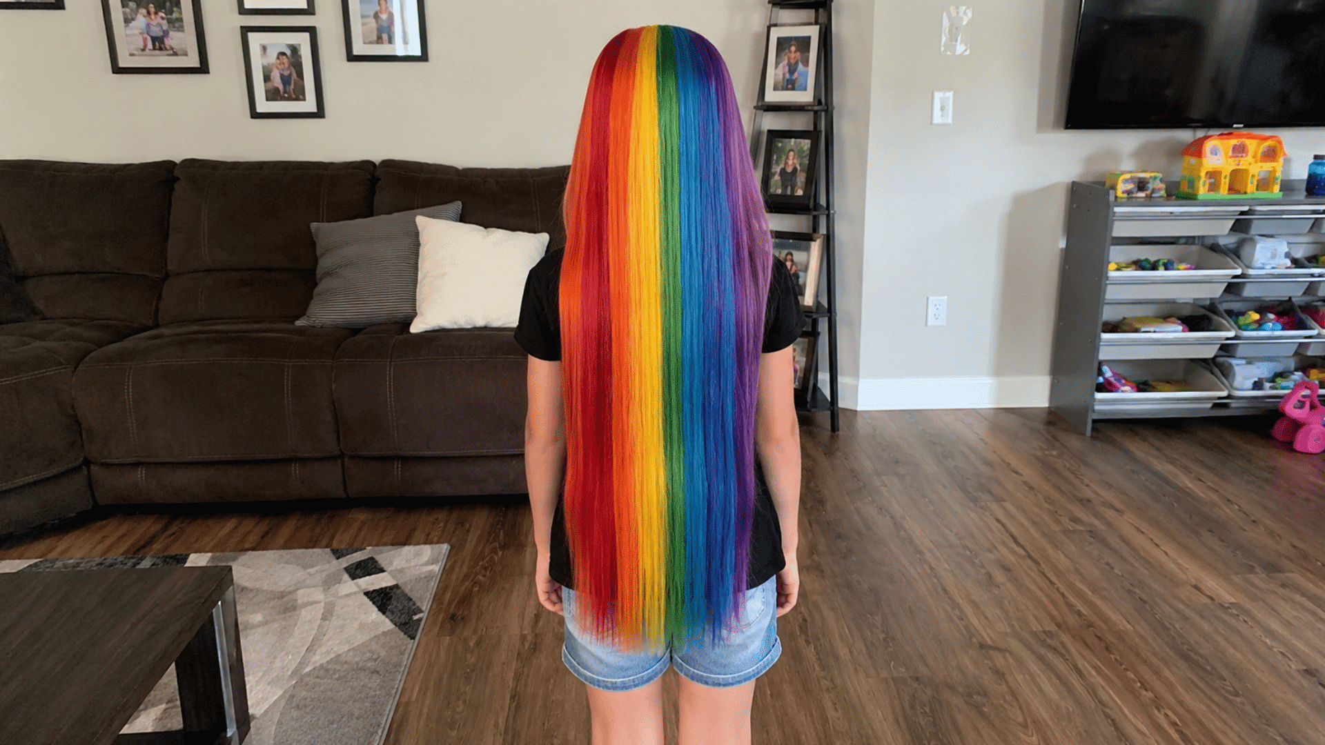 long straight hair dyed in rainbow vertical stripes like a crayon box