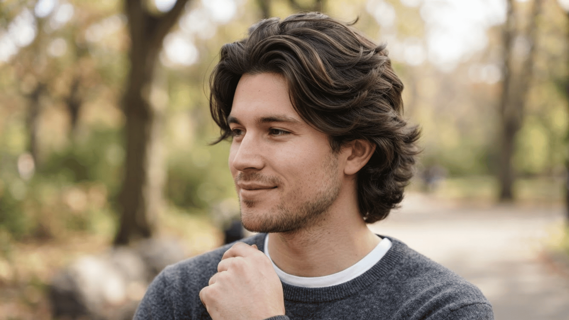 man with layered flow haircut outdoors showing thick textured hair and natural movement