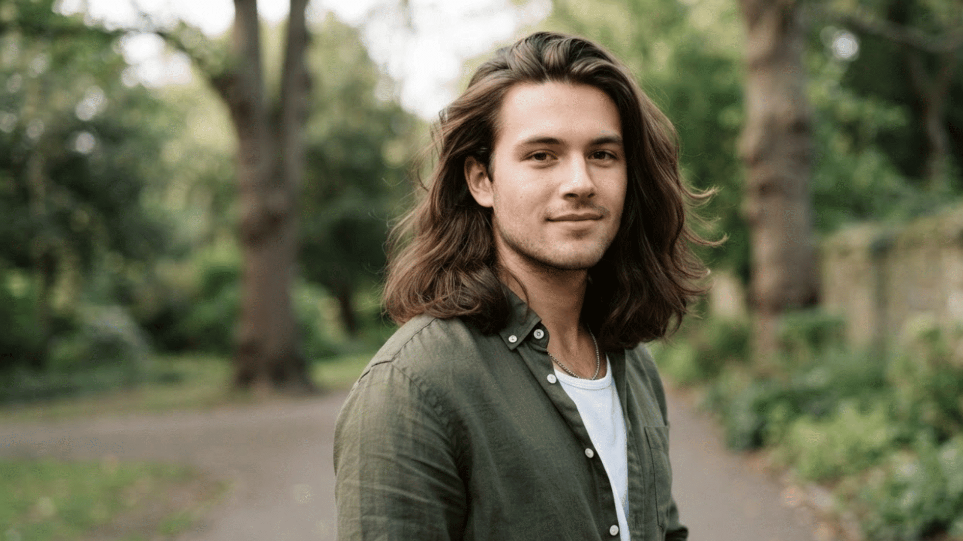 man with long flow haircut outdoors showing layered hair texture and natural movement