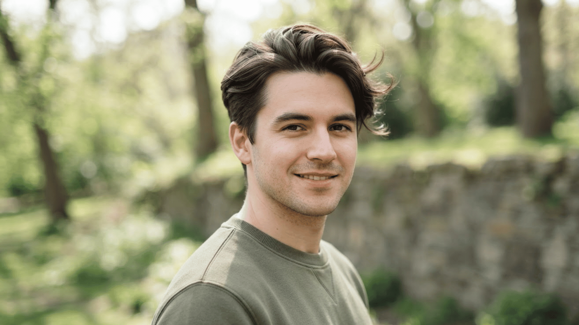 man with short flow haircut outdoors showing textured hair and natural swept back style