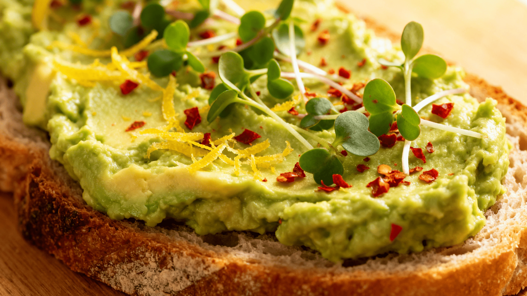 mashed avocado Toast with olive oil drizzle, flaky sea salt, toasted sesame seeds, radish slices